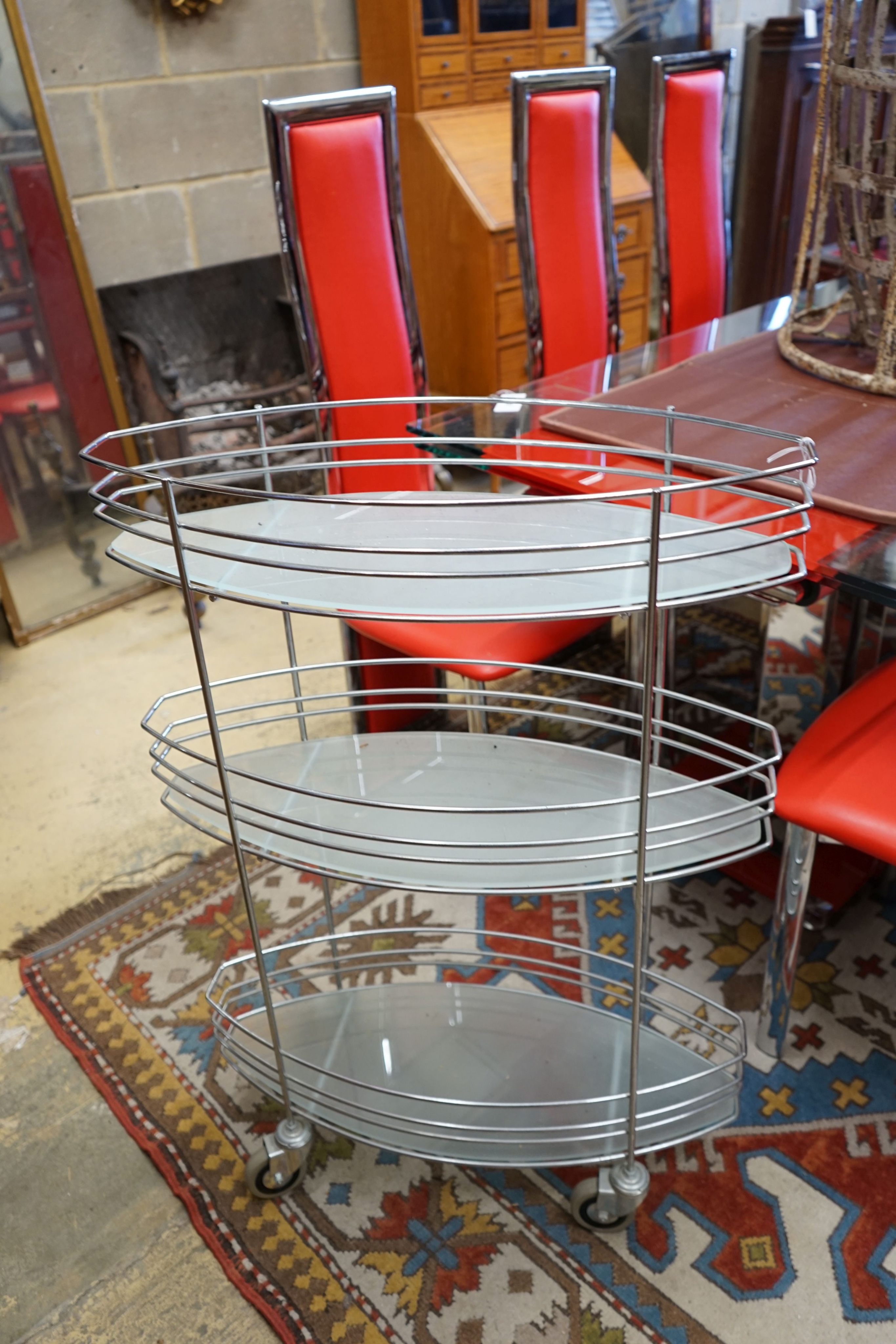 A three tier chrome and glass service trolley, width 65cm depth 27cm height 93cm